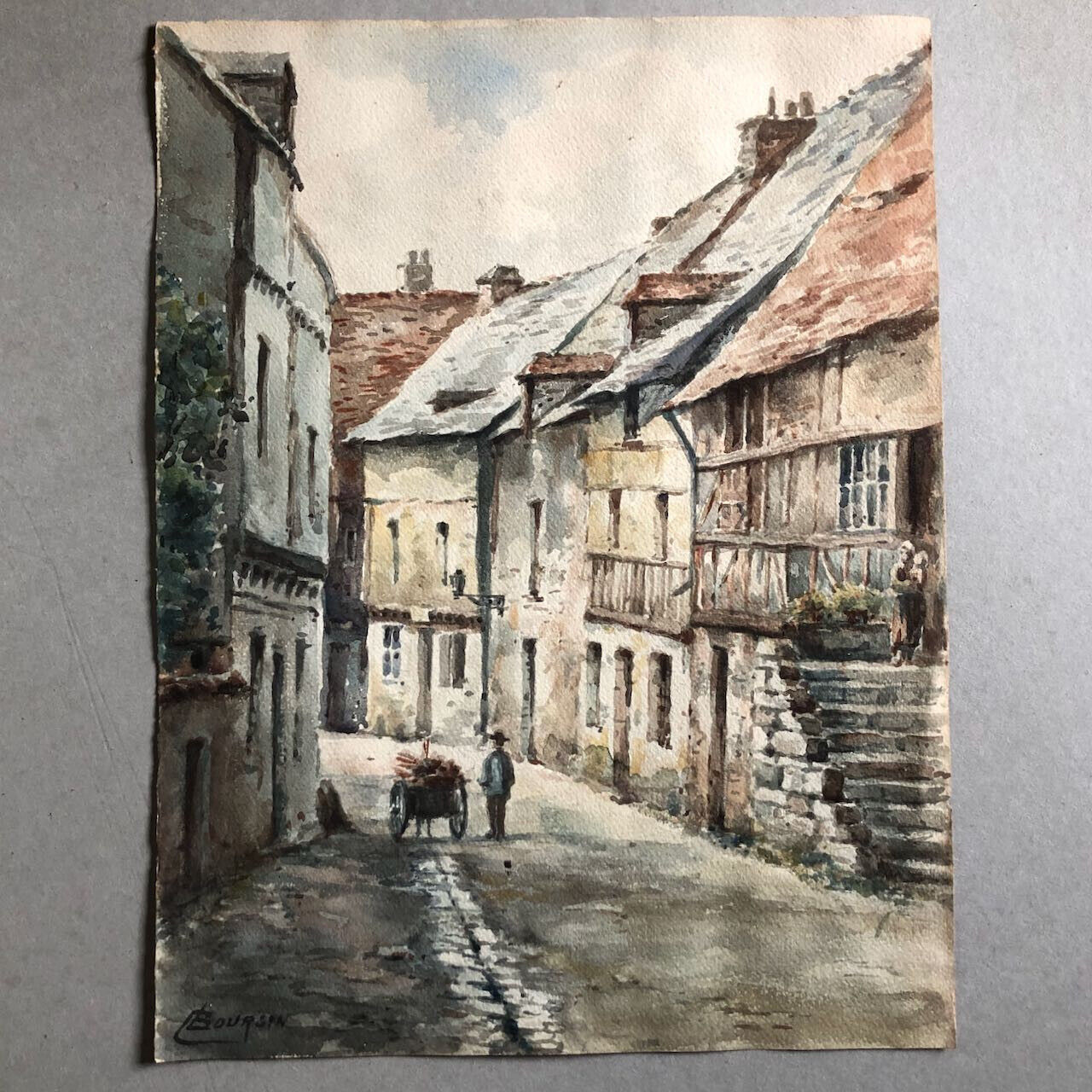 Édouard Boursin — ruelle de village animée — aquarelle signée en bas à gauche.